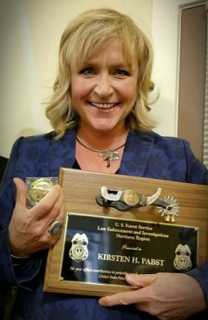 Kristen Pabst holding US Forest Service Award 